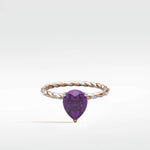 Violet Elm Engagement Ring with a pear-shaped amethyst on a twisted, two-tone rose and white gold band with diamond accents.