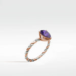 Violet Elm Engagement Ring featuring a purple gemstone on a twisted rose and white gold diamond band.