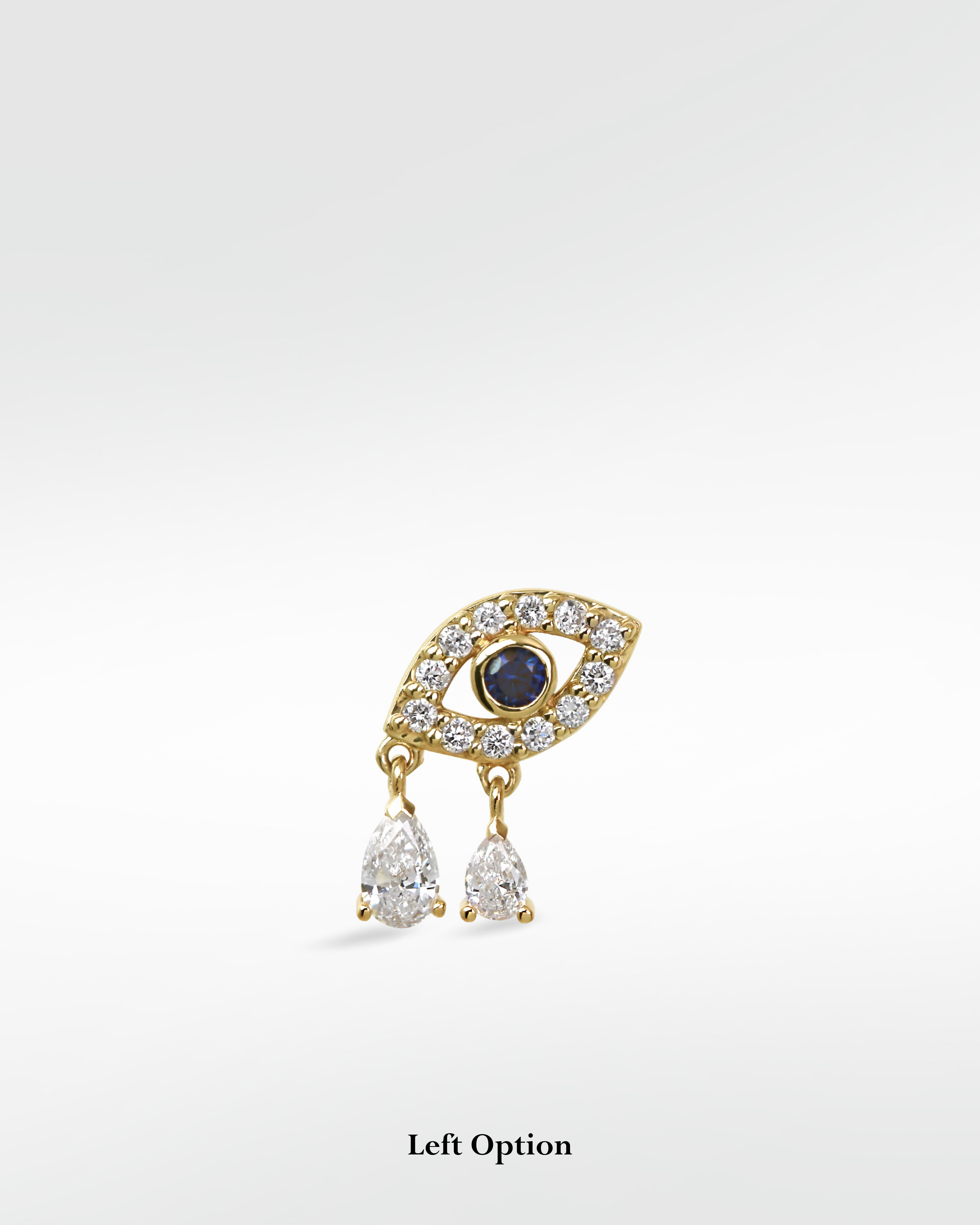 Left Option of a 14k gold Evil Eye earring with a sapphire center, diamond pavé, and two dangling pear-shaped diamonds.