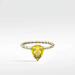 Canary Elm Engagement Ring with a pear-cut yellow gemstone on a twisted two-tone gold and diamond band.