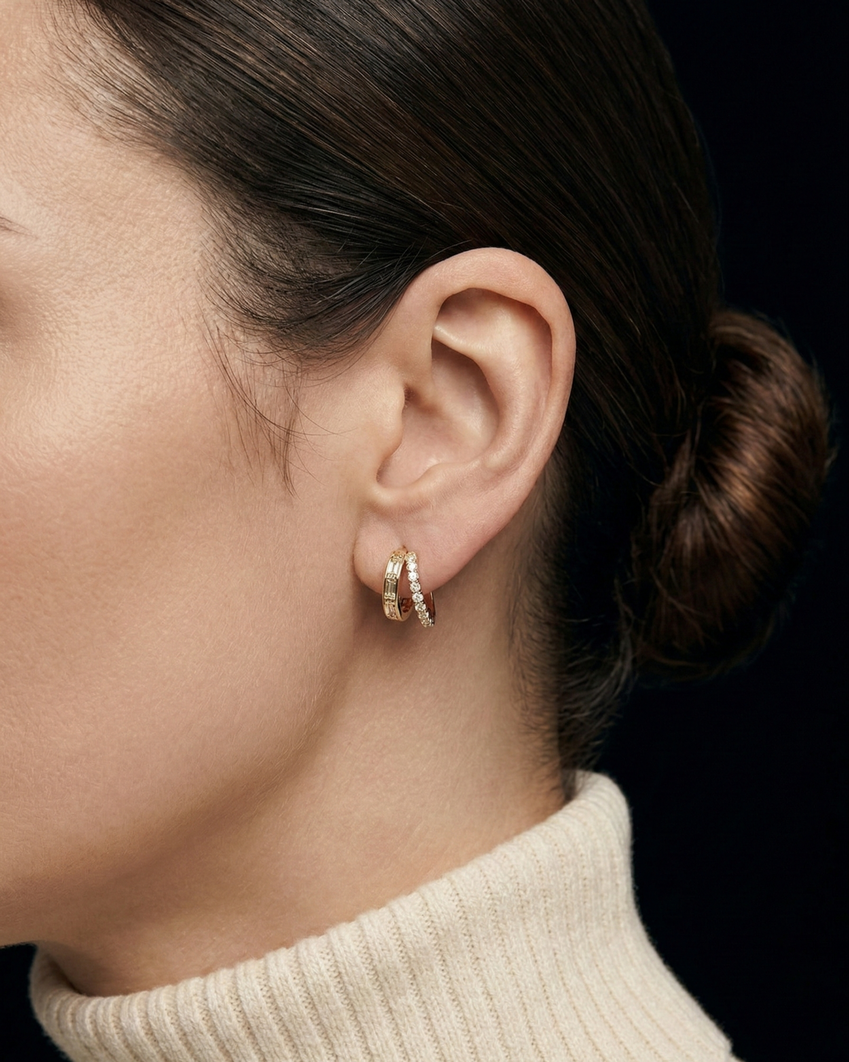 Close-up of a model wearing the gold Modernist Double Diamond Hoop earrings with baguette and brilliant-cut diamonds.