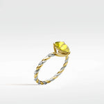 Canary Elm Engagement Ring with a yellow oval diamond on a two-tone twisted band with diamond accents.