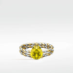 Canary Elm Engagement Ring with a pear-shaped yellow stone on a twisted gold and silver band with diamonds.