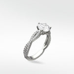 The Zamifolia Engagement Ring in platinum, featuring a brilliant cut diamond on a twisted pavé diamond band.