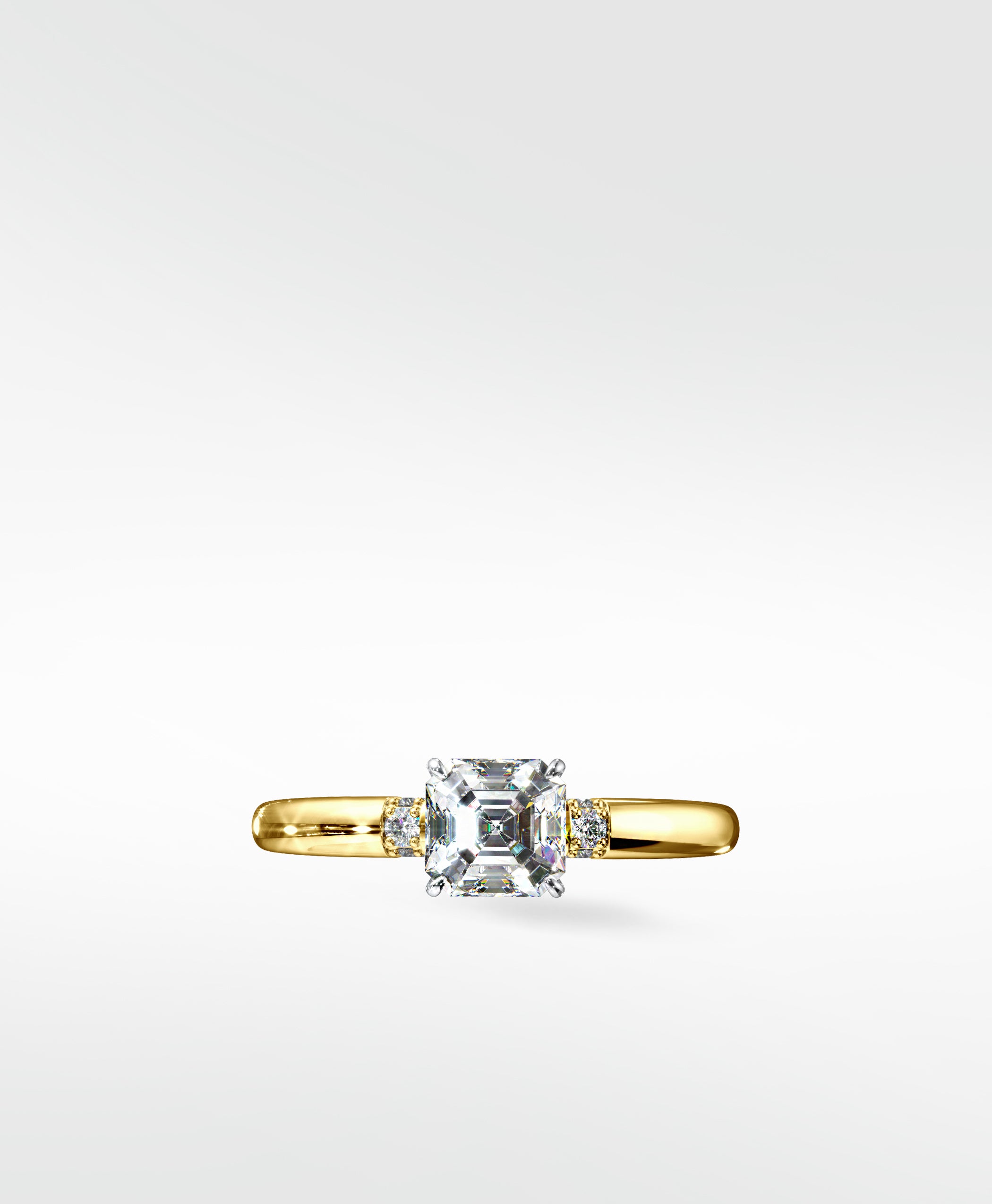 Cacao Engagement Ring in yellow gold, featuring a large Asscher-cut diamond flanked by two smaller round diamonds.