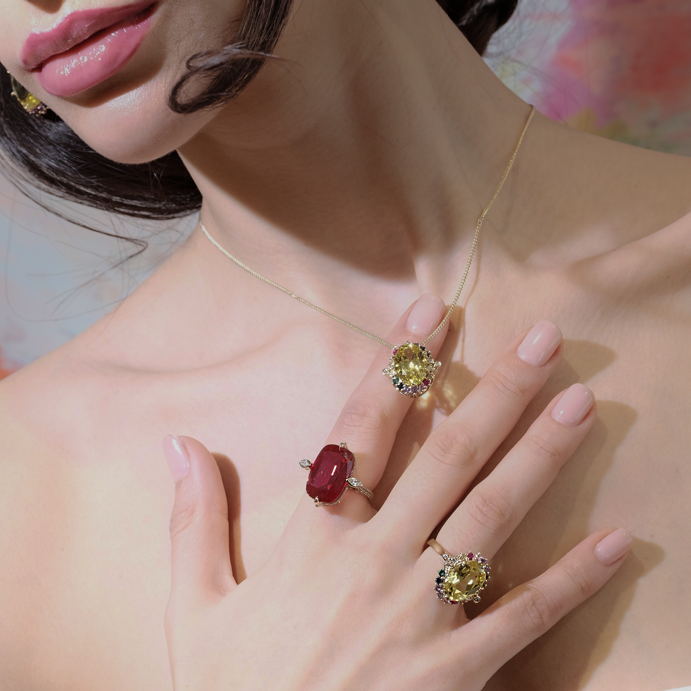 Model showcasing the elegant Buckingham Ruby Ring alongside a colorful gemstone necklace and matching ring.