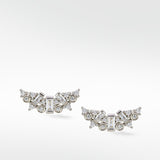 A pair of Lark & Berry Dove Duet white gold earrings with a cluster of baguette and round diamonds in a curved wing design.