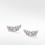 Lark & Berry's Dove Duet diamond earrings, with baguette and round-cut diamonds clustered in a delicate wing shape.