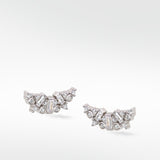 Lark & Berry's Dove Duet diamond earrings, with baguette and round-cut diamonds clustered in a delicate wing shape.
