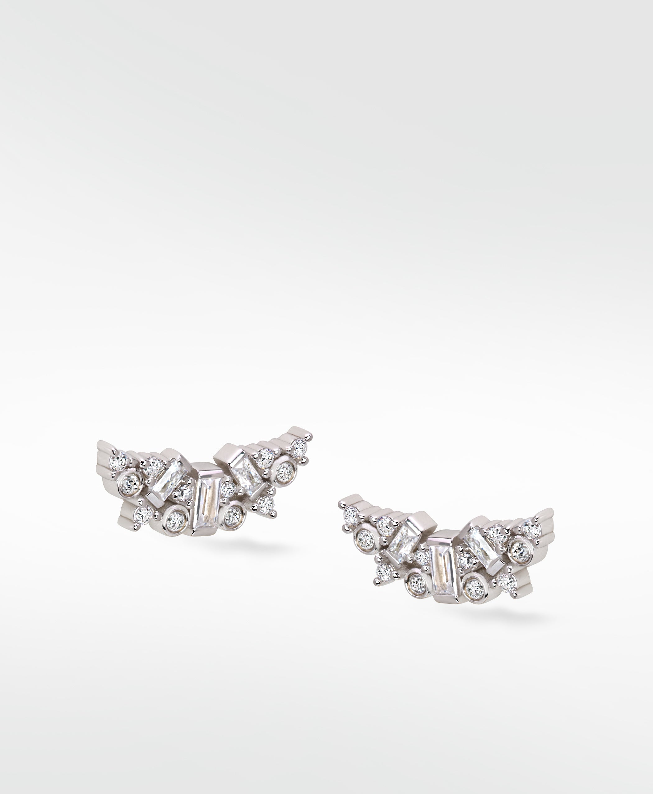 Lark & Berry's Dove Duet diamond earrings, with baguette and round-cut diamonds clustered in a delicate wing shape.
