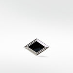 A single polished silver Clarke Cufflink with a black rhombus inlay and two rows of pavé diamonds.