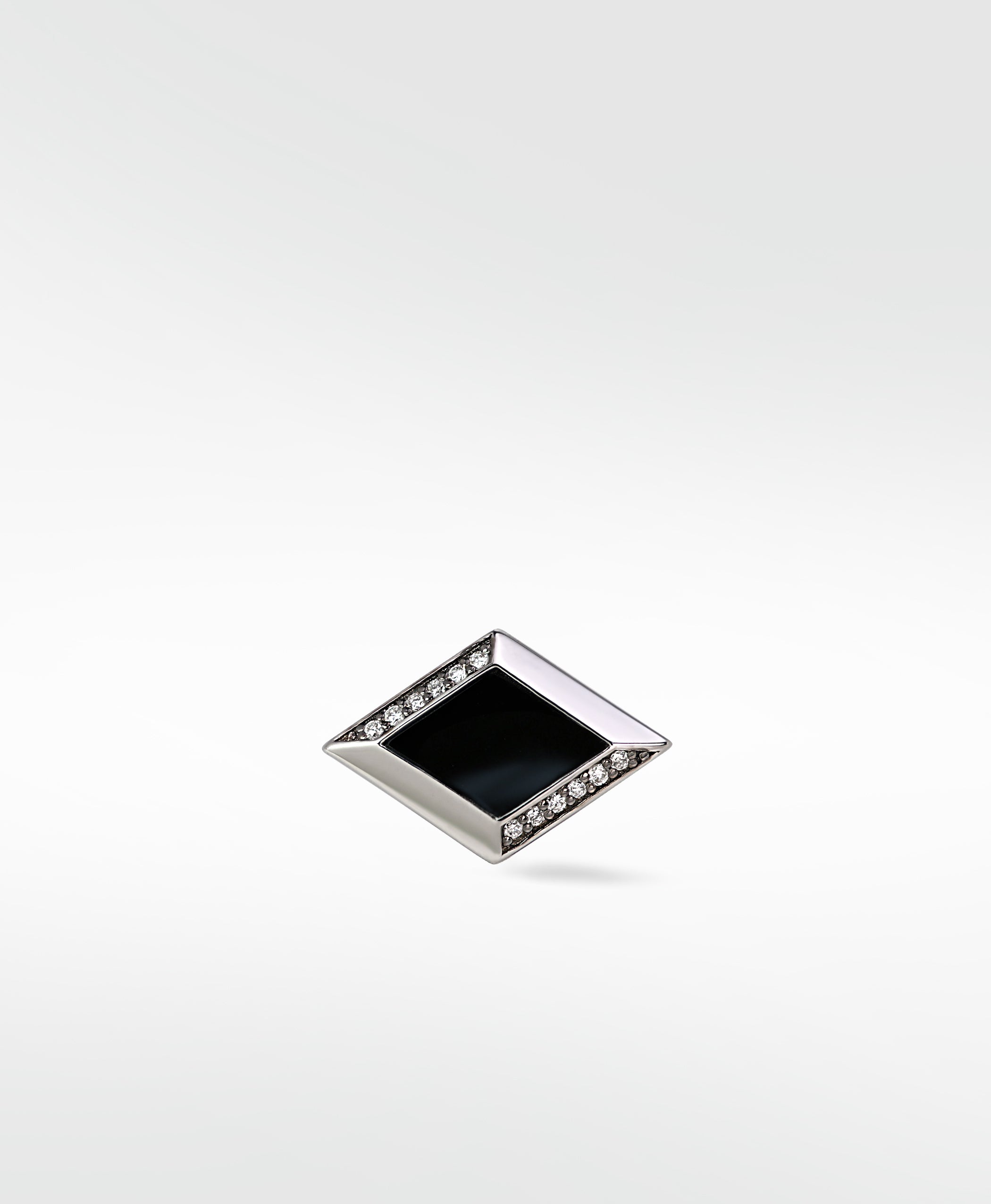 A single polished silver Clarke Cufflink with a black rhombus inlay and two rows of pavé diamonds.