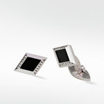 Pair of Clarke Cufflinks in matte silver, featuring a diamond shape with black inlay and pavé diamond details.