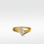 The Elder Engagement Ring in yellow gold, featuring a modern, sweeping band that cradles a brilliant princess-cut diamond.