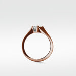 Side profile of the Elder Engagement Ring in rose gold, featuring a princess cut diamond in a modern tension setting.