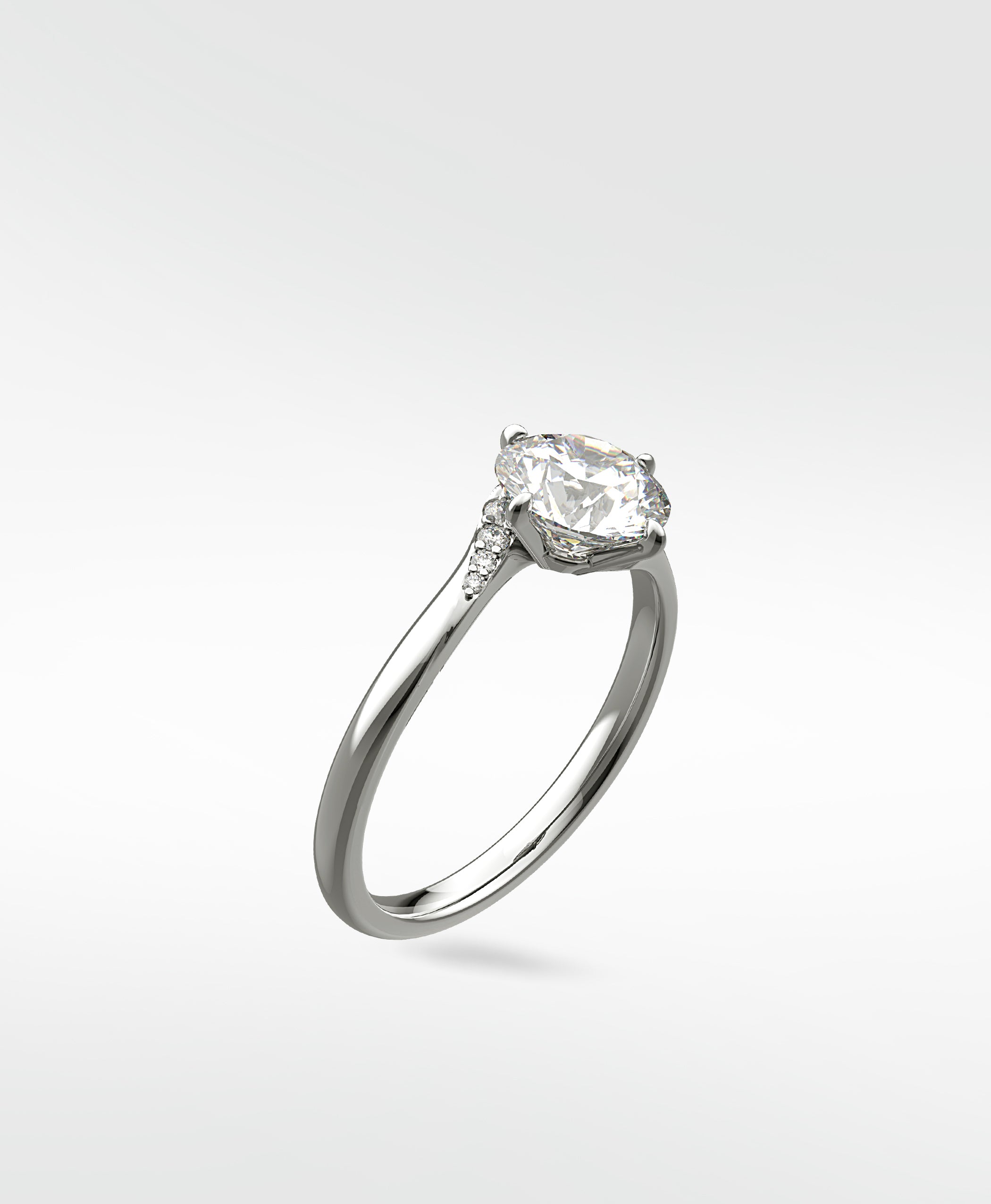 Vine Diamond Engagement Ring in platinum with a round brilliant cut center stone and delicate pavé diamond accents.