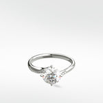A platinum Vine Diamond Engagement Ring with a round brilliant diamond and pavé accents on the band.