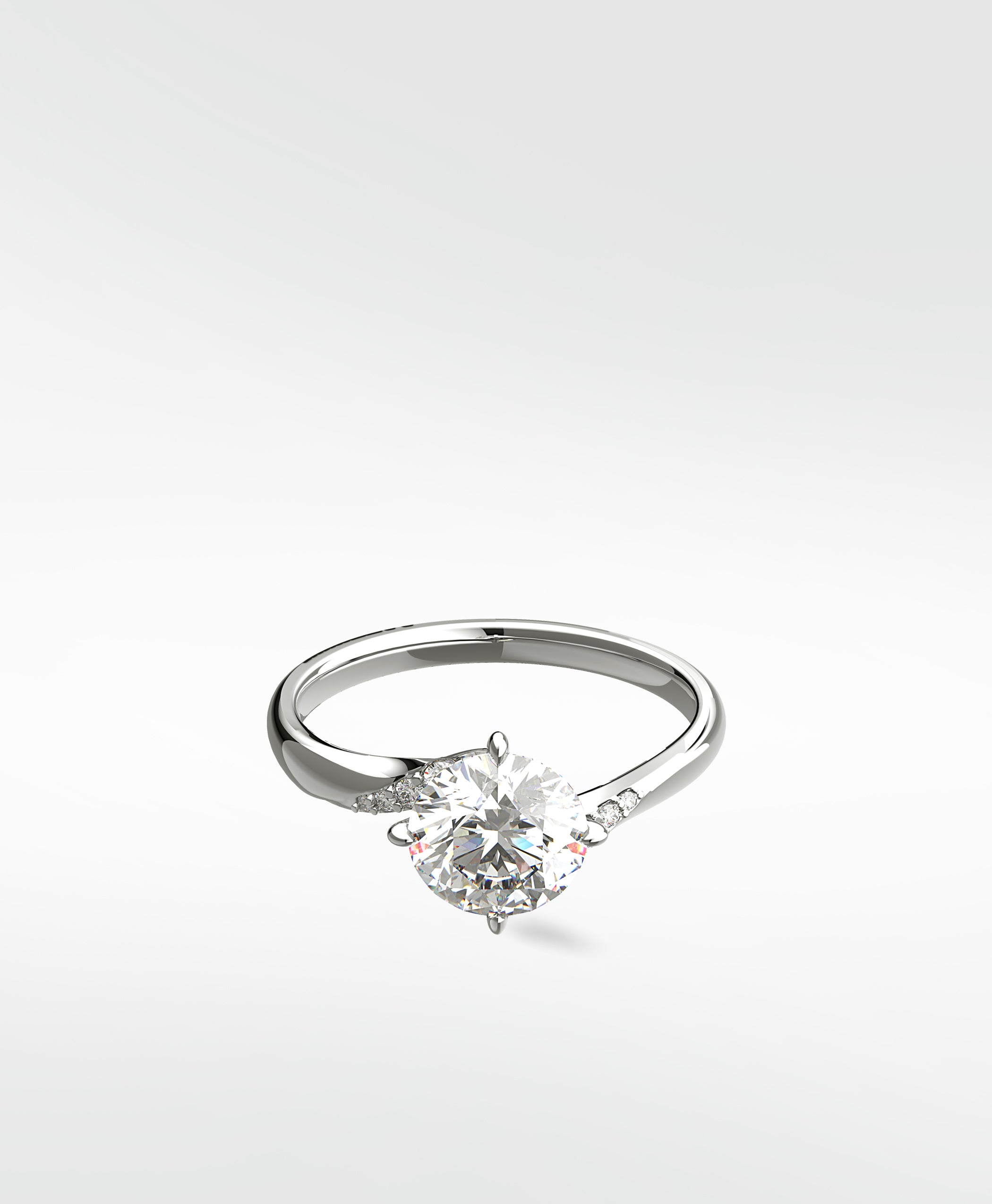 A platinum Vine Diamond Engagement Ring with a round brilliant diamond and pavé accents on the band.