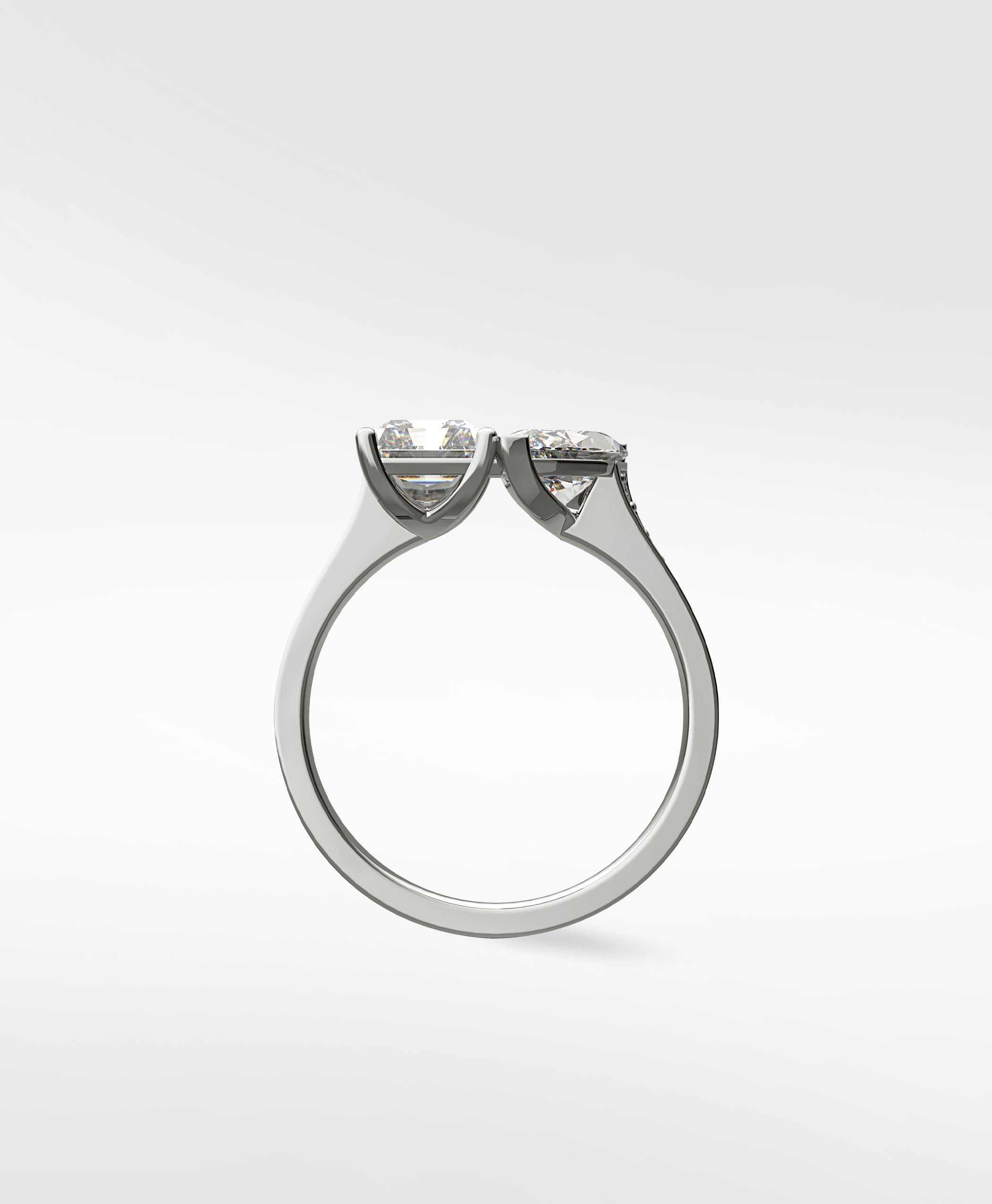 Side profile of the Wisteria Toi et Moi engagement ring with two cushion-cut diamonds set in platinum.