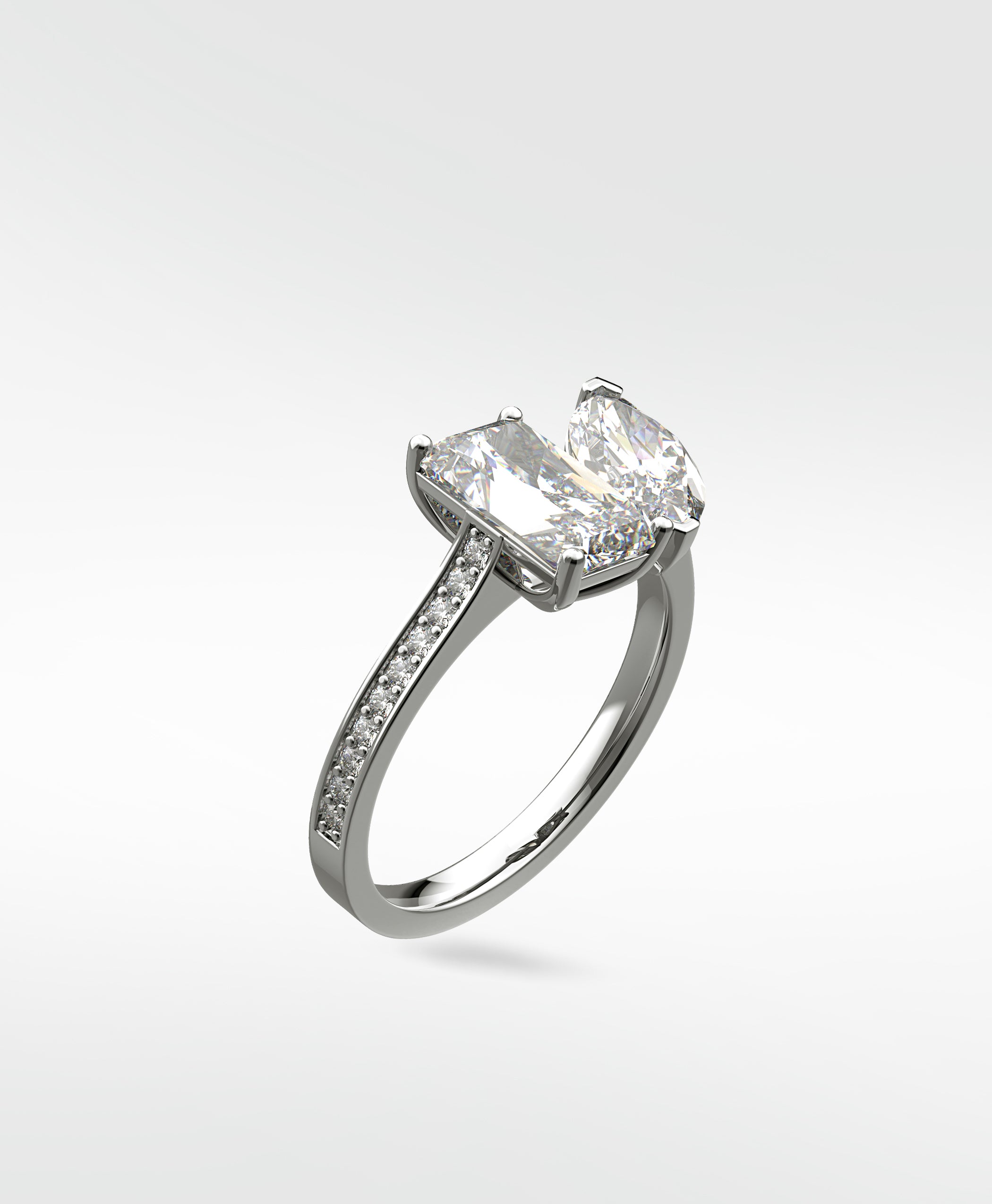 Wisteria Toi et Moi diamond engagement ring in platinum, featuring a rectangular and a pear-cut diamond on a pavé band.