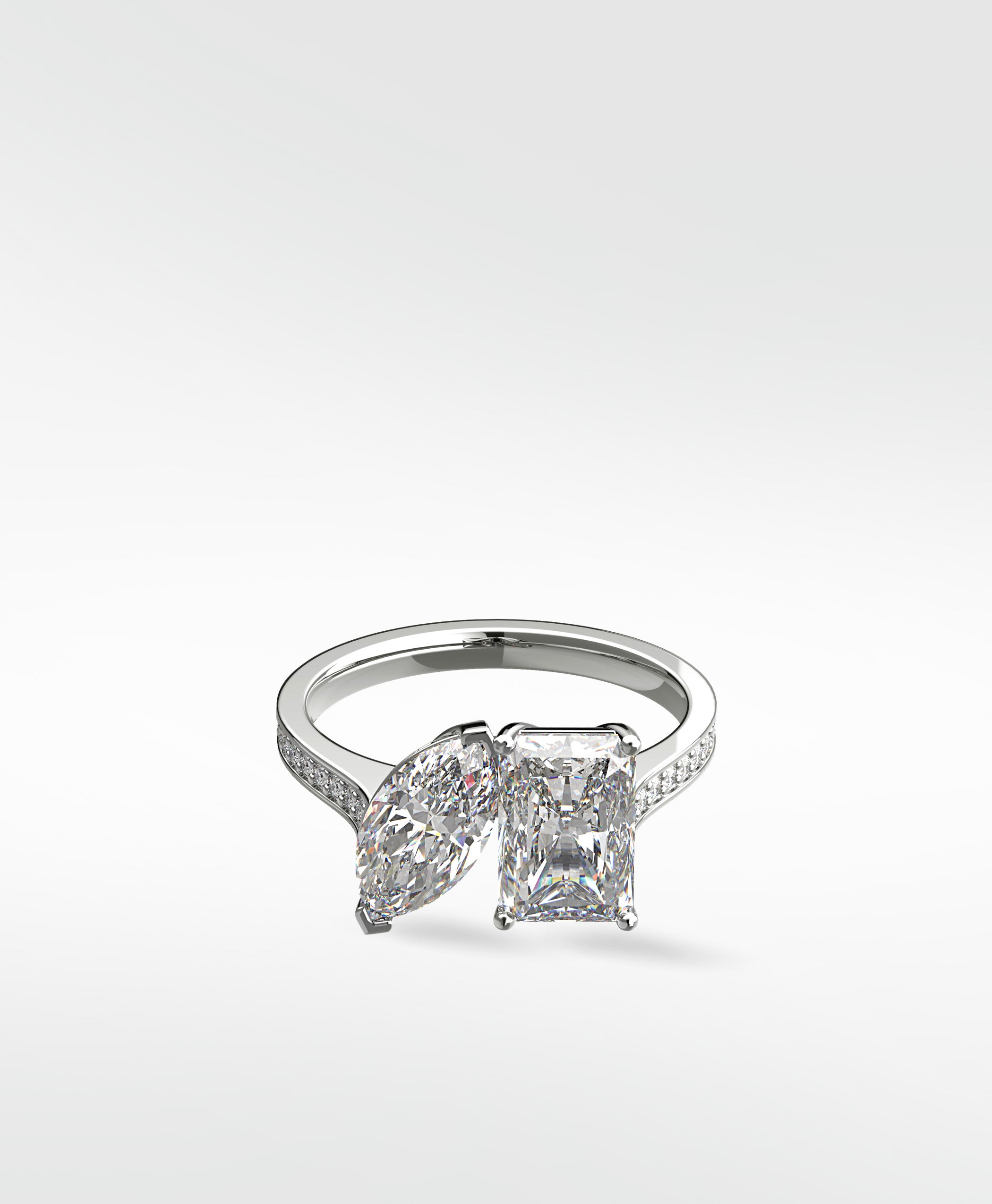 Platinum Wisteria Toi et Moi engagement ring with a marquise and radiant cut diamond on a pavé band.