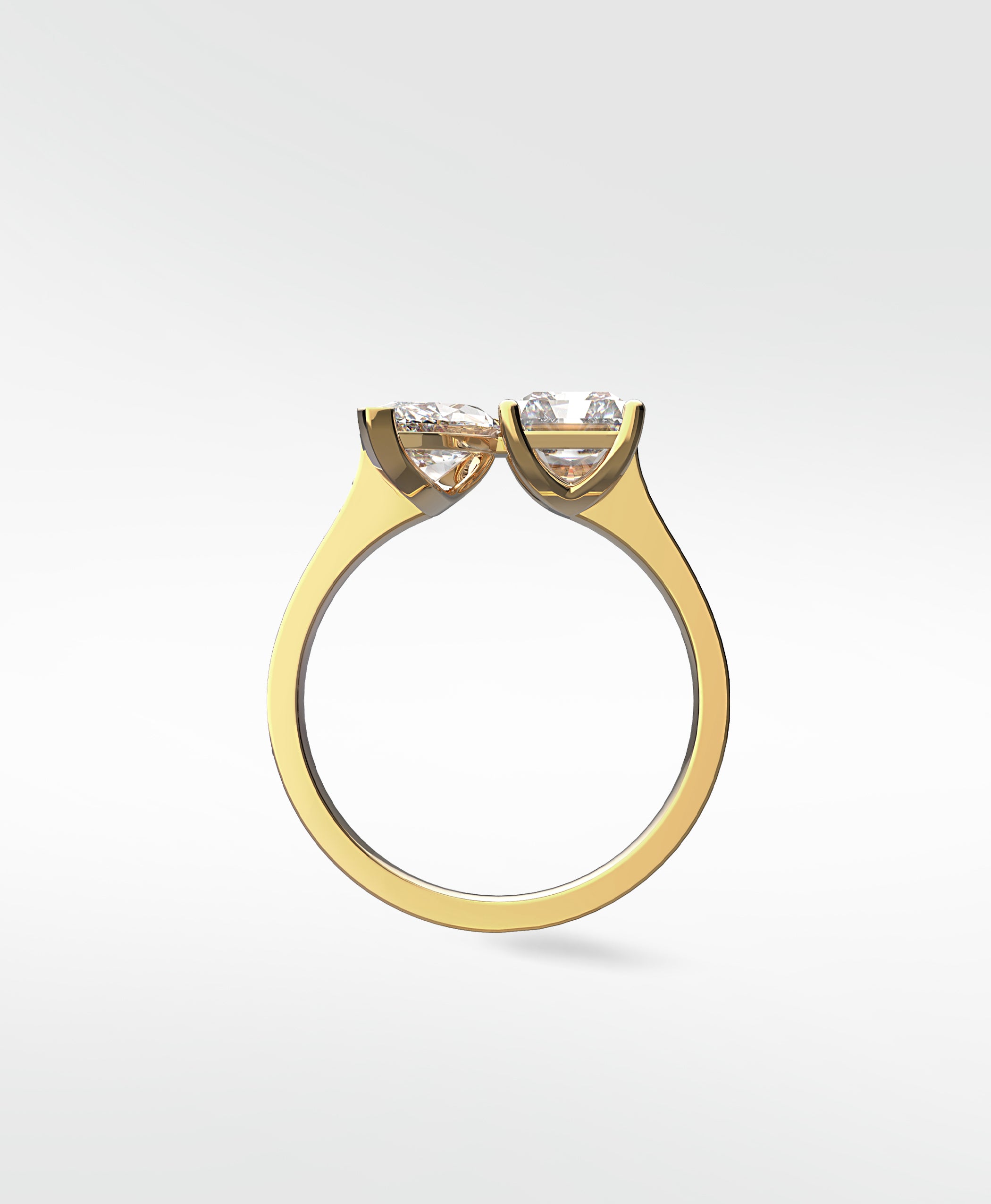 Side profile of the Wisteria Toi et Moi engagement ring in yellow gold, showing its two heart-shaped diamond setting.