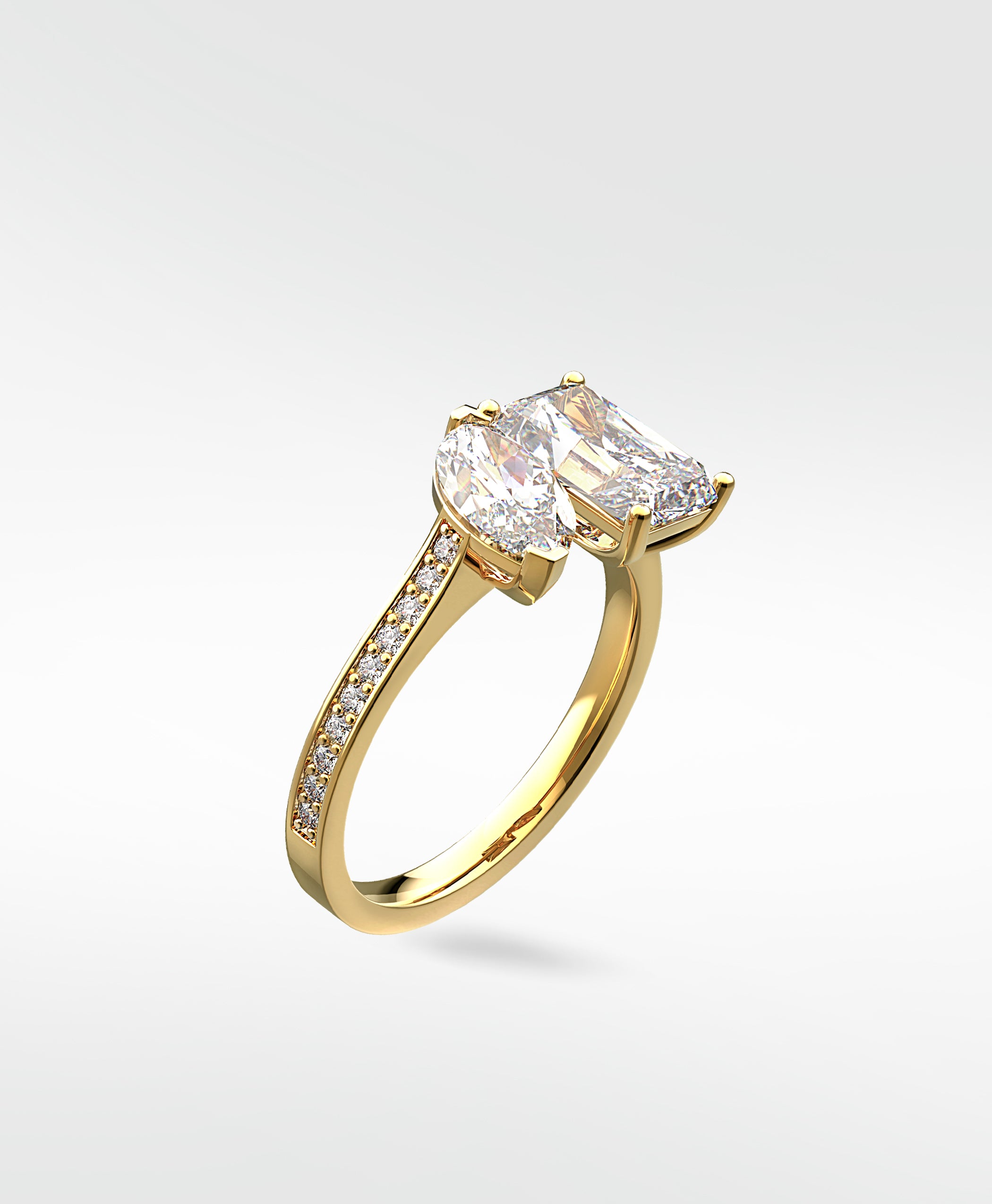 Wisteria Diamond Engagement Ring in yellow gold, featuring a Toi et Moi design with a pear and radiant cut diamond on a pavé band.