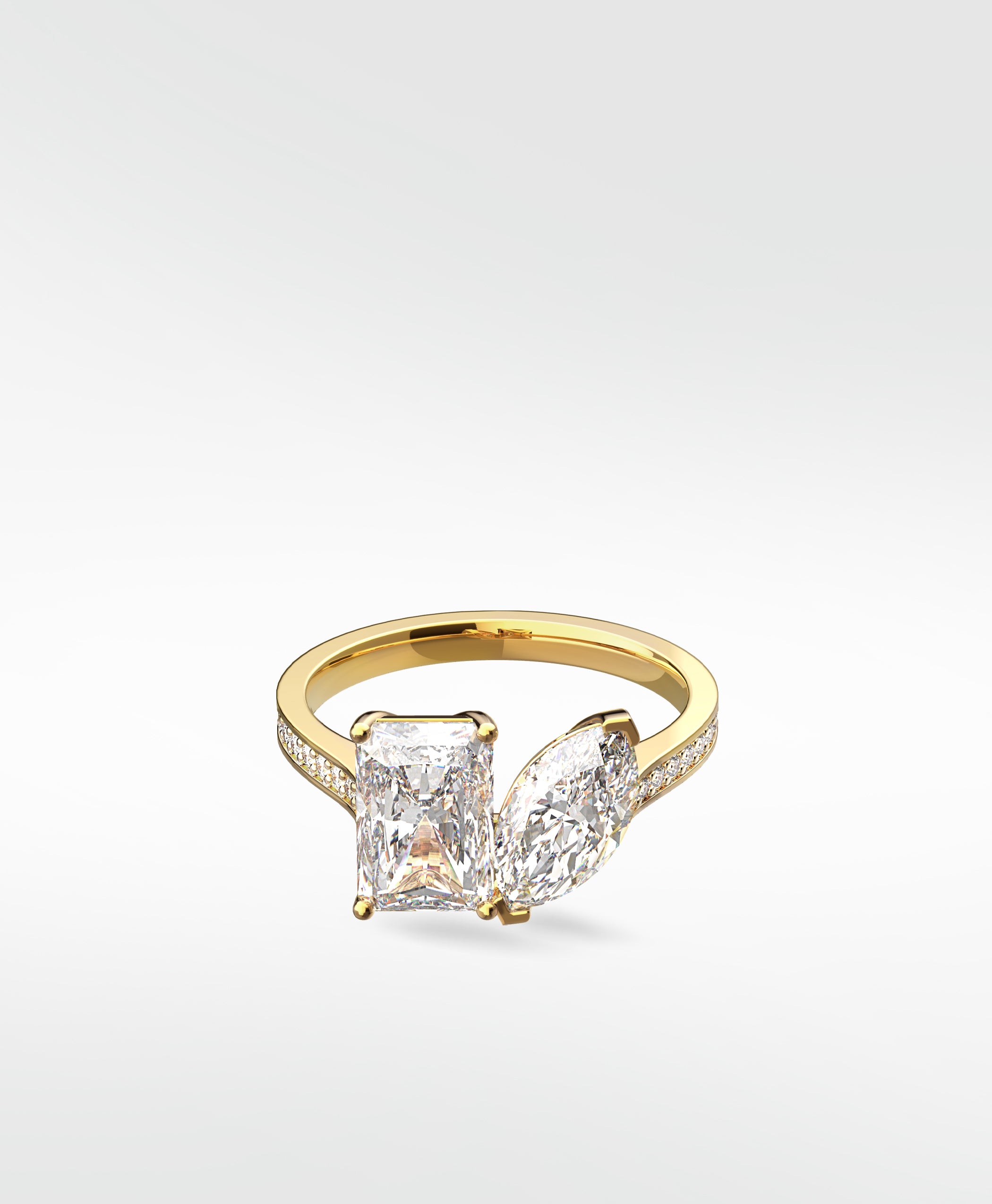 Wisteria Toi et Moi engagement ring in yellow gold with a radiant and a marquise cut diamond on a pavé band.