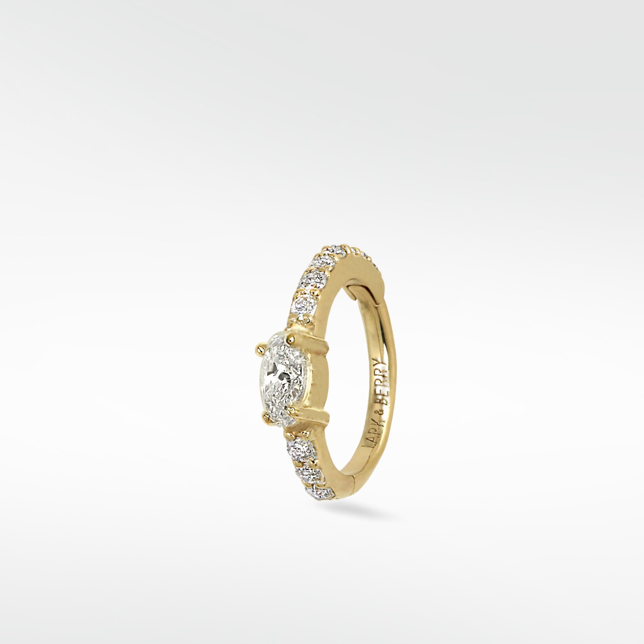 Lark & Berry Modernist Oval Diamond Hoop in yellow gold with pavé diamonds, shown at a slight angle on a white background.