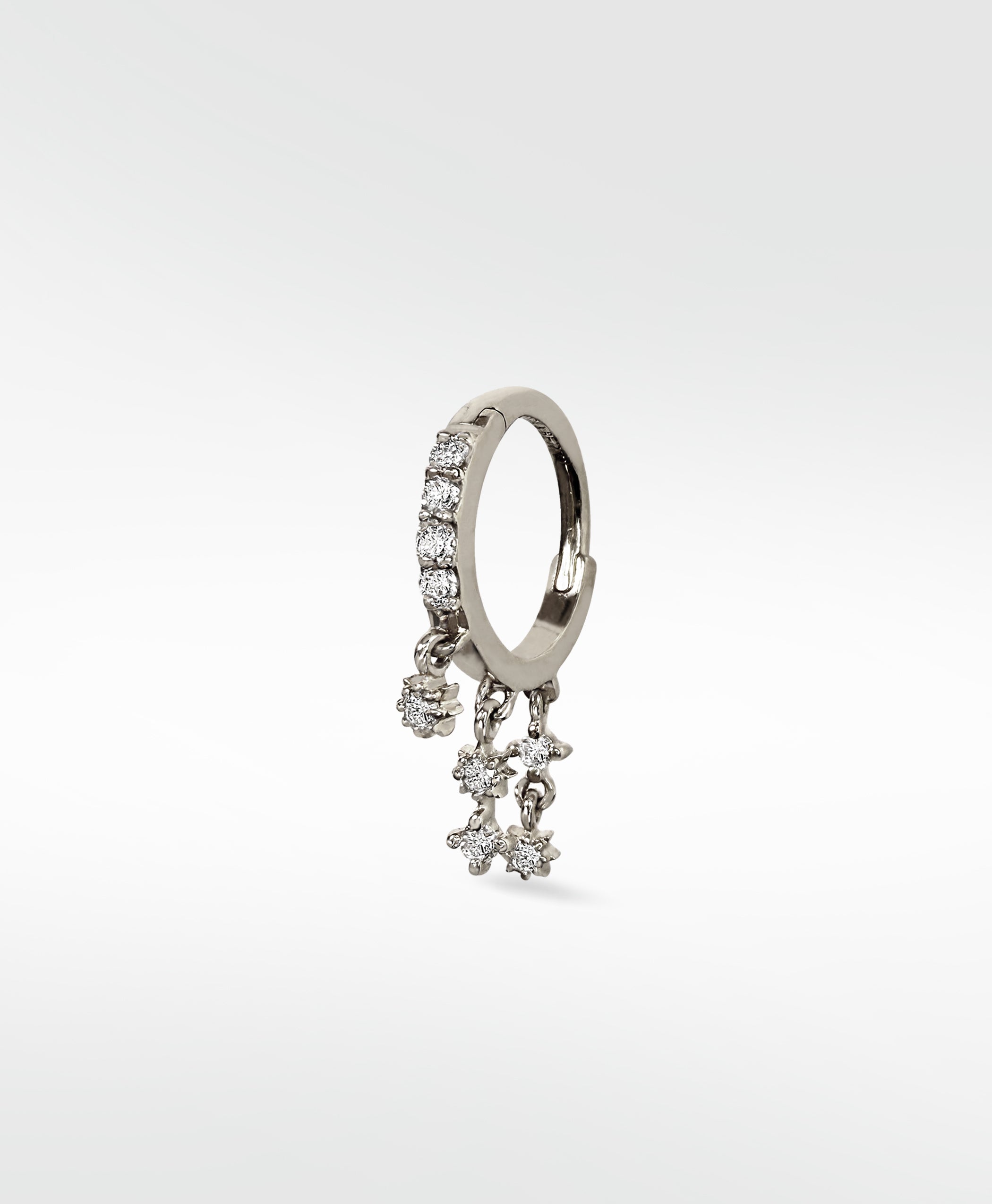 A single Modernist Celestial Drop Hoop earring in white gold, with pavé diamonds on the hoop and dangling diamond star charms.