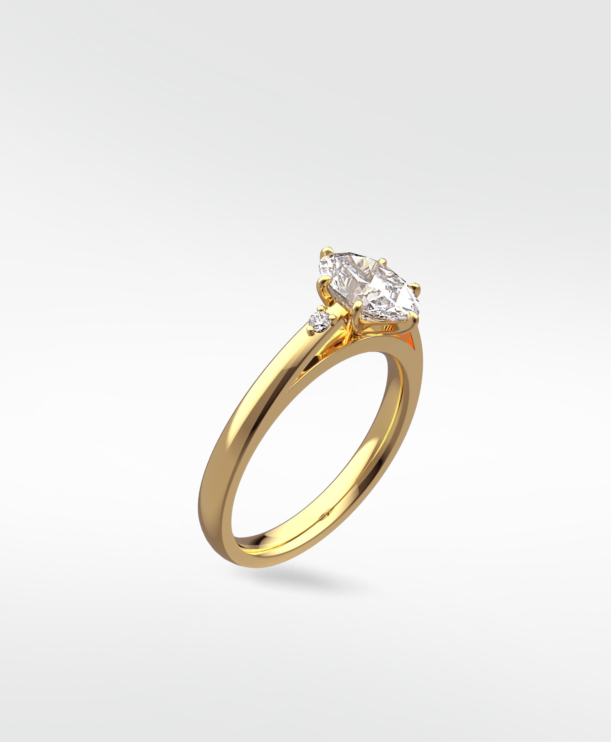 The Kentia Engagement Ring in yellow gold, featuring a marquise-cut diamond with two round accent stones.