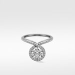 Wild Cherry Diamond Engagement Ring with a round center stone in a halo setting on a twisting pavé band.
