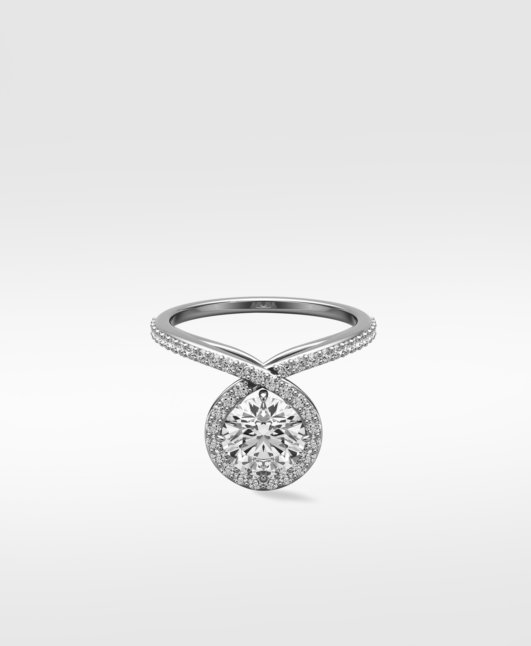 Wild Cherry Diamond Engagement Ring with a round center stone in a halo setting on a twisting pavé band.