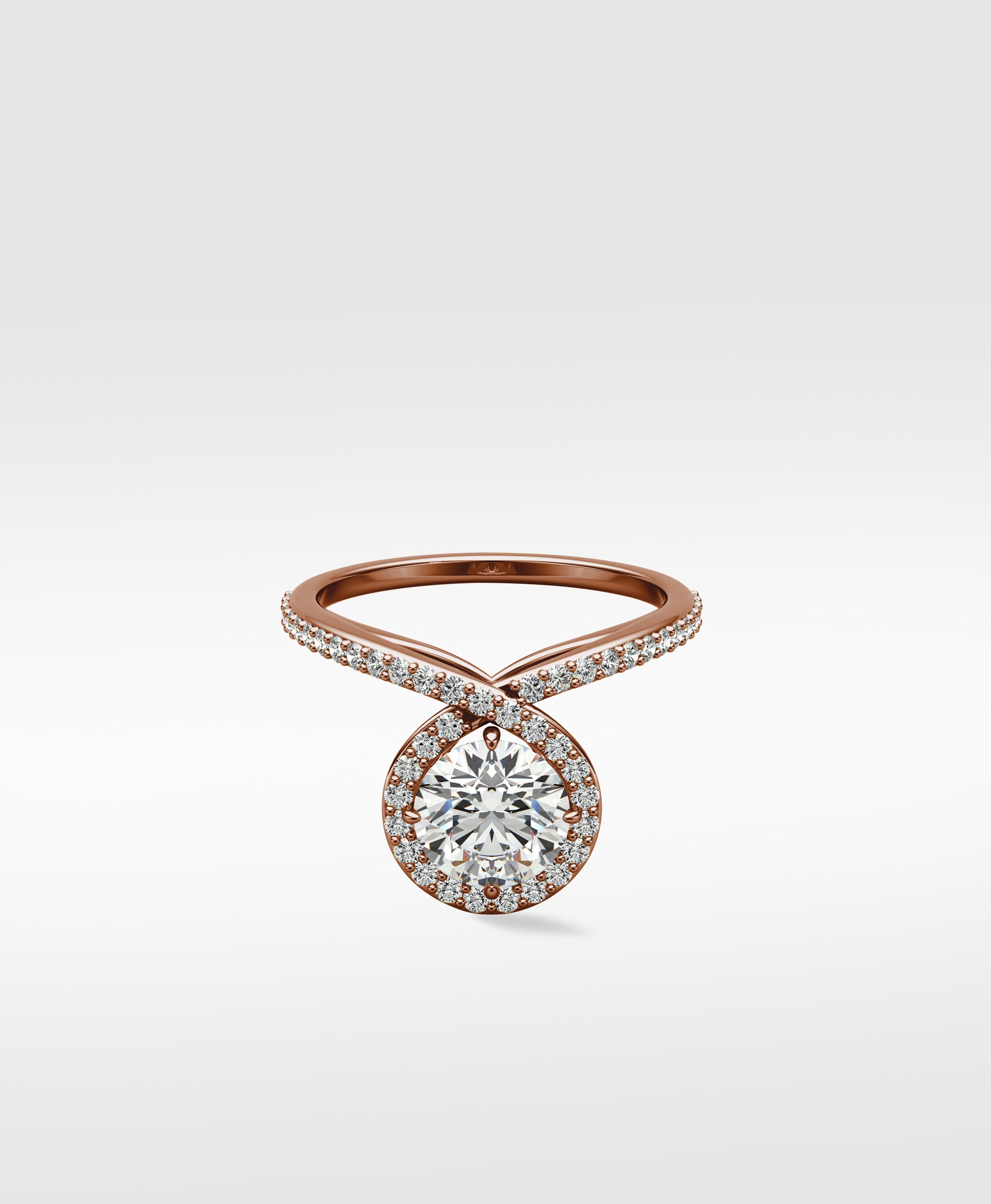 The Wild Cherry Diamond Engagement Ring in rose gold, with a round halo diamond on a twisted pavé band.