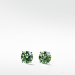 A pair of brilliant round-cut Lime Green Diamond stud earrings in a simple four-prong setting on a white background.