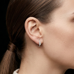 Profile view of a model wearing the elegant Lark & Berry Modernist Oval Diamond Hoop, featuring a central oval diamond.