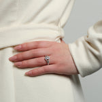 Close-up of the Chestnut Diamond Engagement Ring on a woman's hand, showcasing its marquise-cut diamond and pavé band.