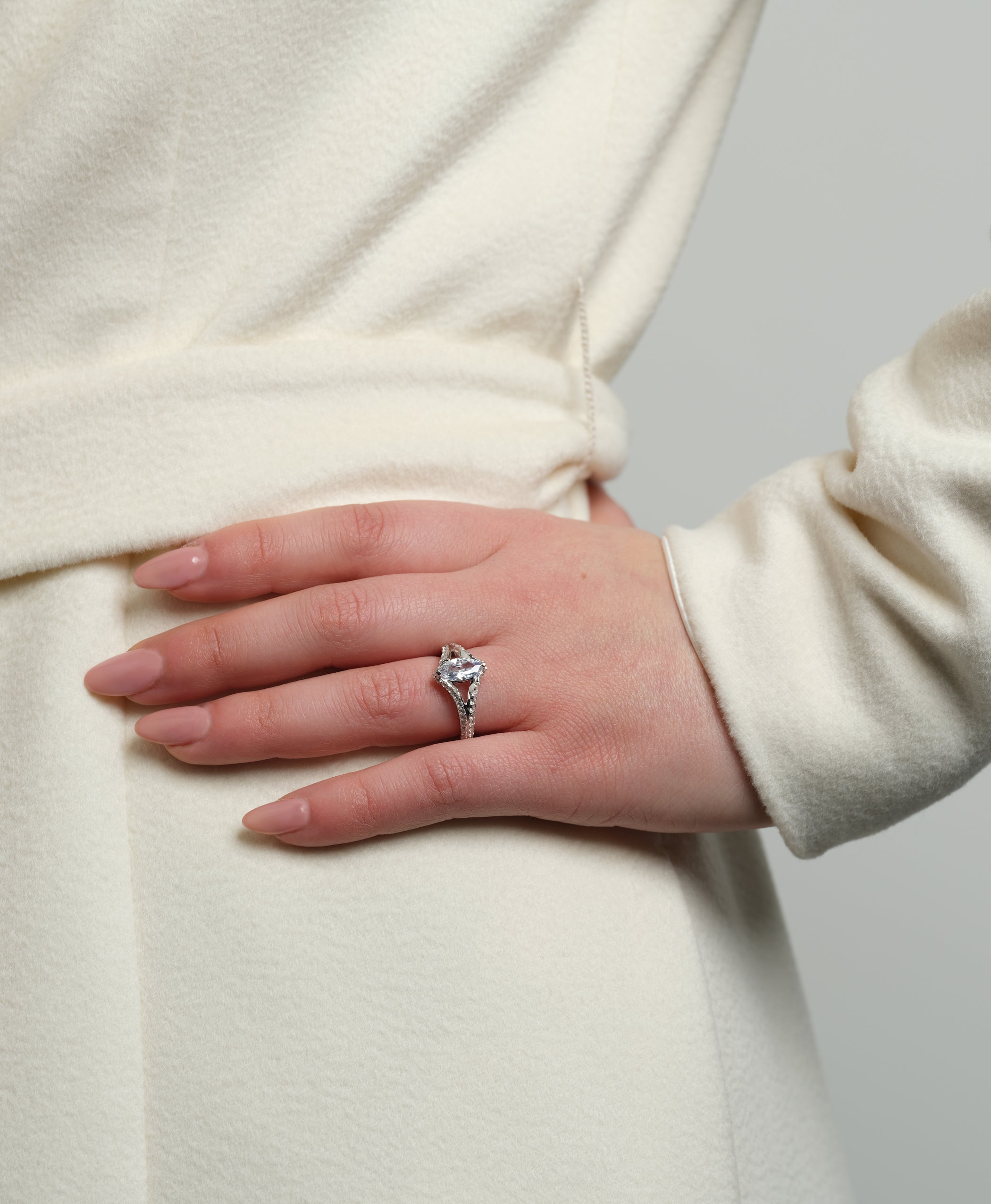 Close-up of the Chestnut Diamond Engagement Ring on a woman's hand, showcasing its marquise-cut diamond and pavé band.