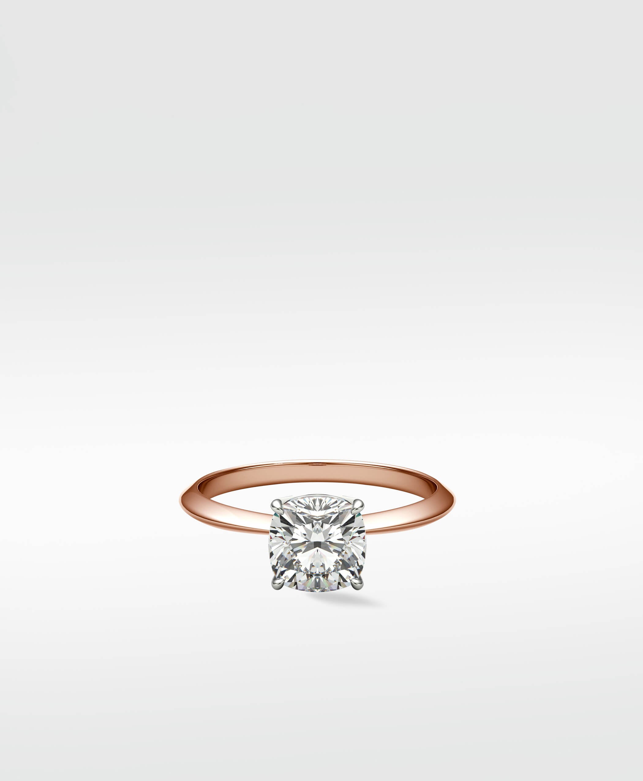 Lark & Berry's Walnut Engagement Ring featuring a brilliant cushion-cut diamond in a solitaire setting on a rose gold band.