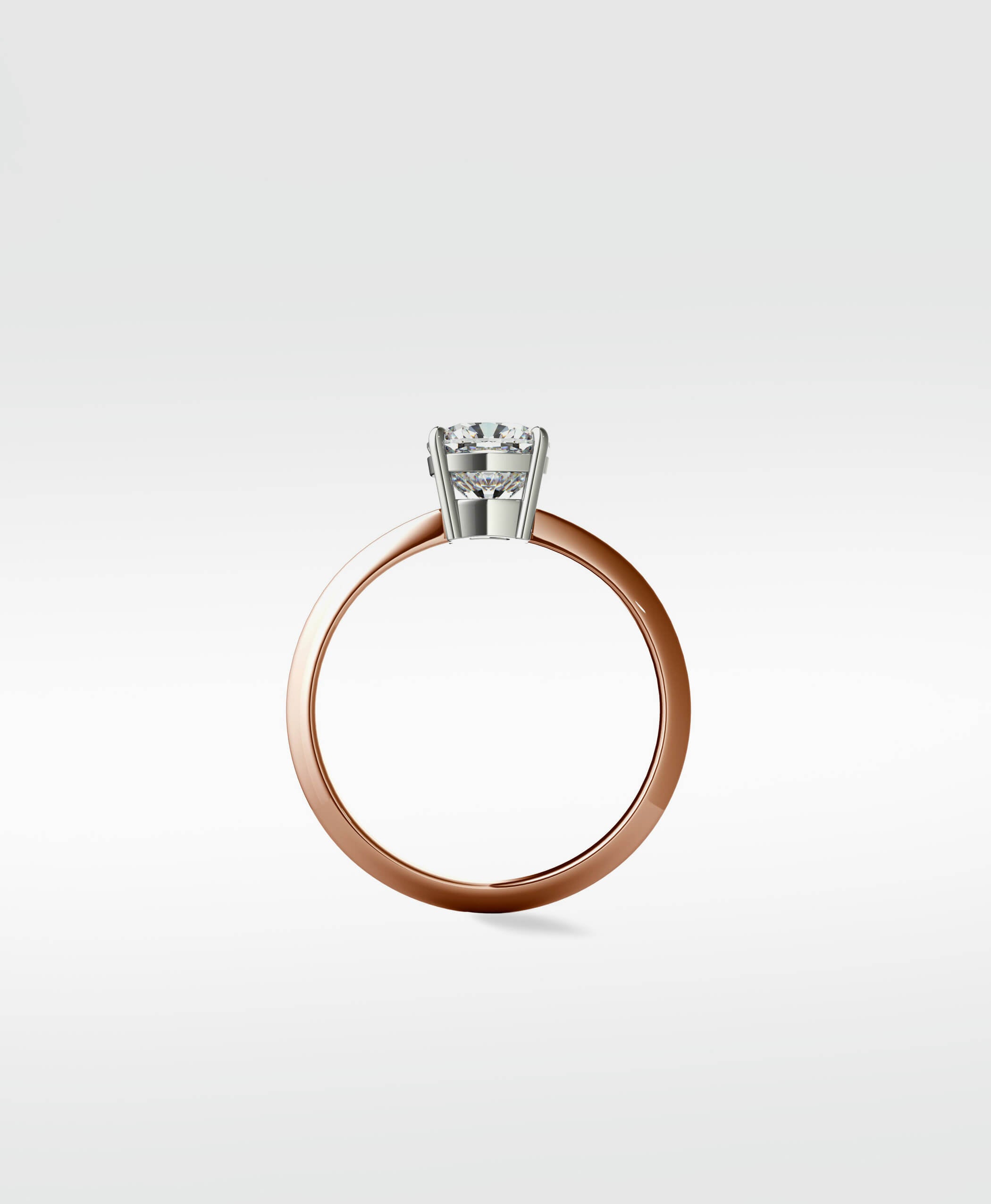 Side profile of the Walnut Engagement Ring with a rose gold band and a round brilliant cut diamond in a white gold setting.