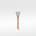 Side profile of the Walnut Engagement Ring with a rose gold band and a lab-grown diamond solitaire in a white gold setting.