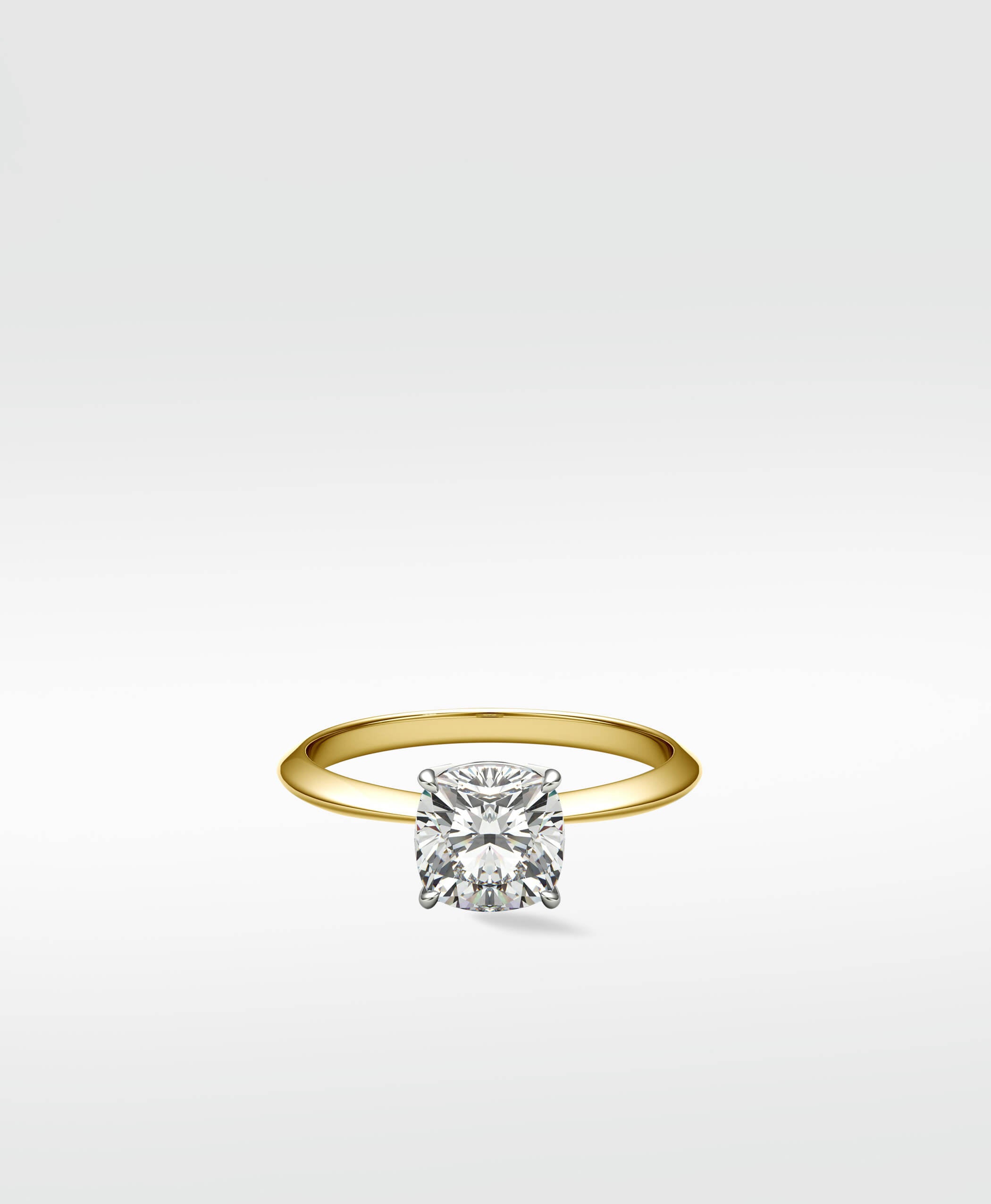Walnut Engagement Ring with a cushion-cut diamond solitaire on a classic yellow gold band.