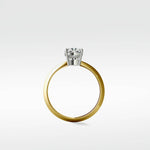 Profile view of the Walnut Engagement Ring with a round diamond in a white gold basket setting on a polished yellow gold band.