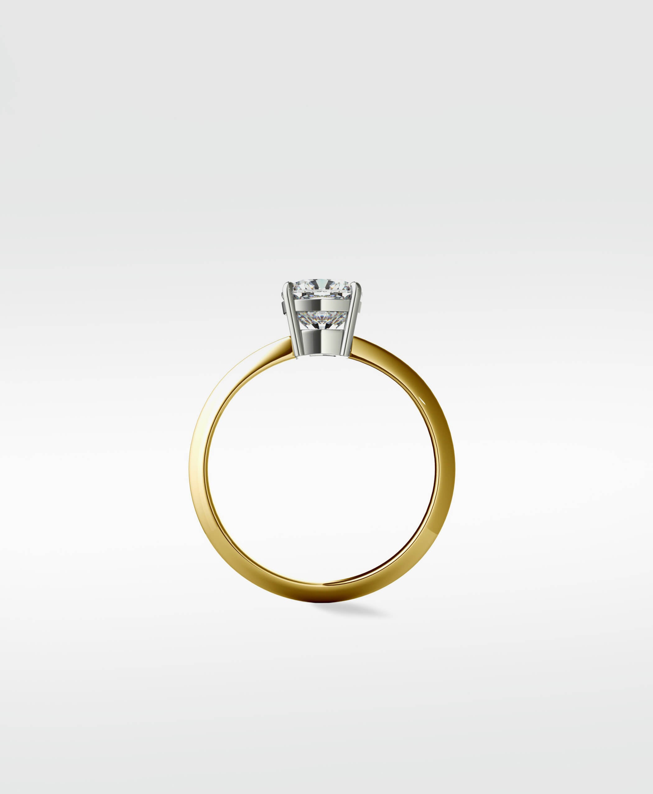 Profile view of the Walnut Engagement Ring with a round diamond in a white gold basket setting on a polished yellow gold band.