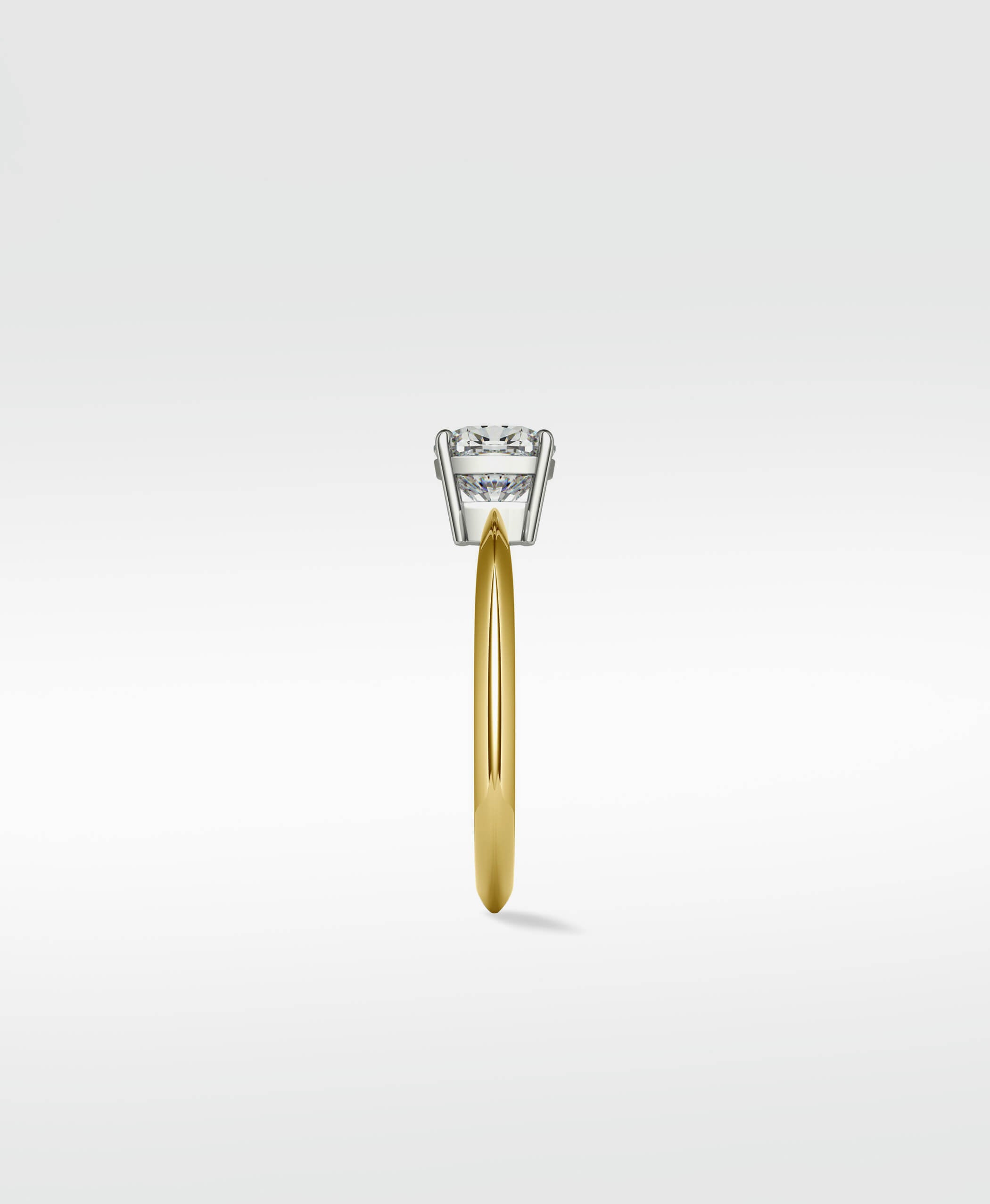 Side profile of the Walnut Engagement Ring with a round diamond in a white gold setting on a polished yellow gold band.