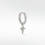 Lark & Berry Celestial Diamond Charm, a diamond star, hanging from a pavé diamond white gold hoop earring on a white background.
