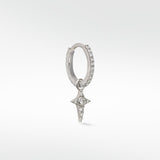 Lark & Berry Celestial Diamond Charm, a diamond star, hanging from a pavé diamond white gold hoop earring on a white background.