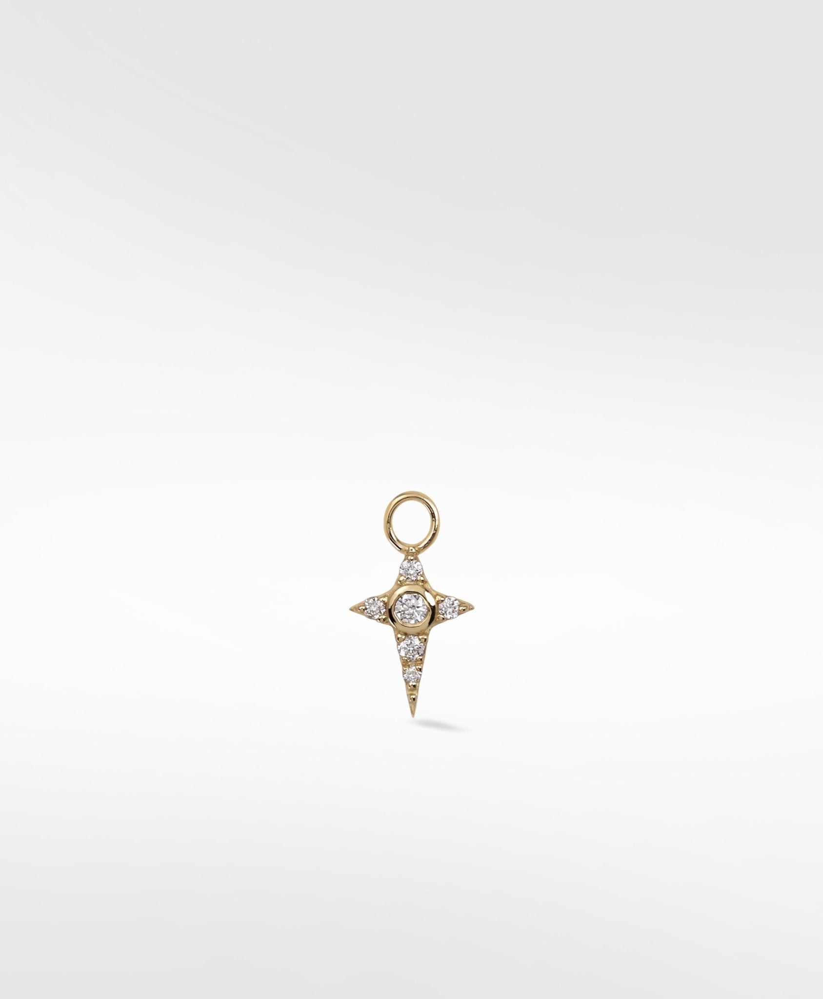 A yellow gold Celestial Diamond Charm shaped like a four-pointed star, set with a central and pavé diamonds.