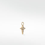 Lark & Berry's Celestial Diamond Charm in a gold, four-pointed star design set with a central round diamond and smaller accents.