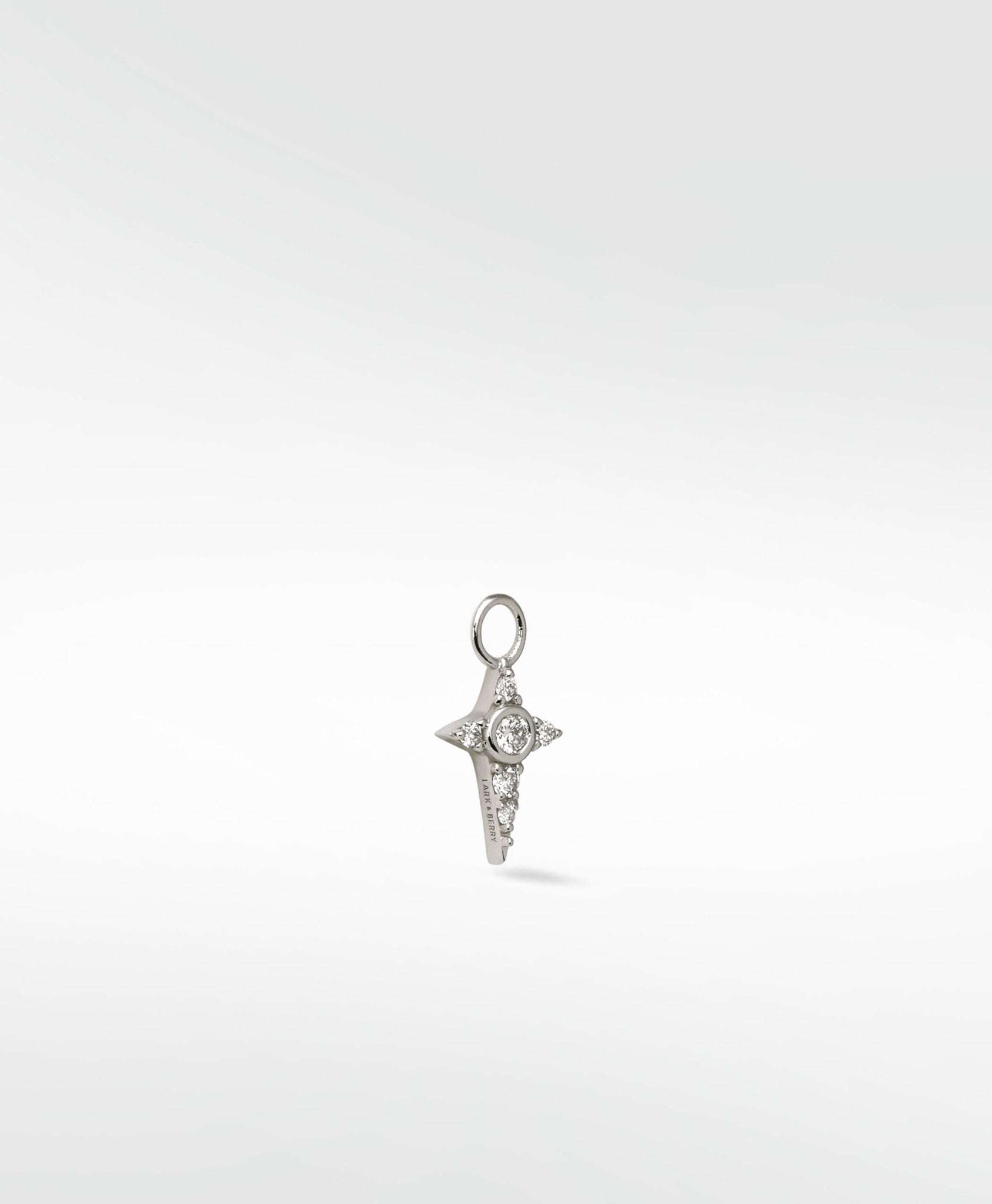 Lark & Berry Celestial Diamond Charm in white gold, shaped like a four-pointed star with a central round diamond.